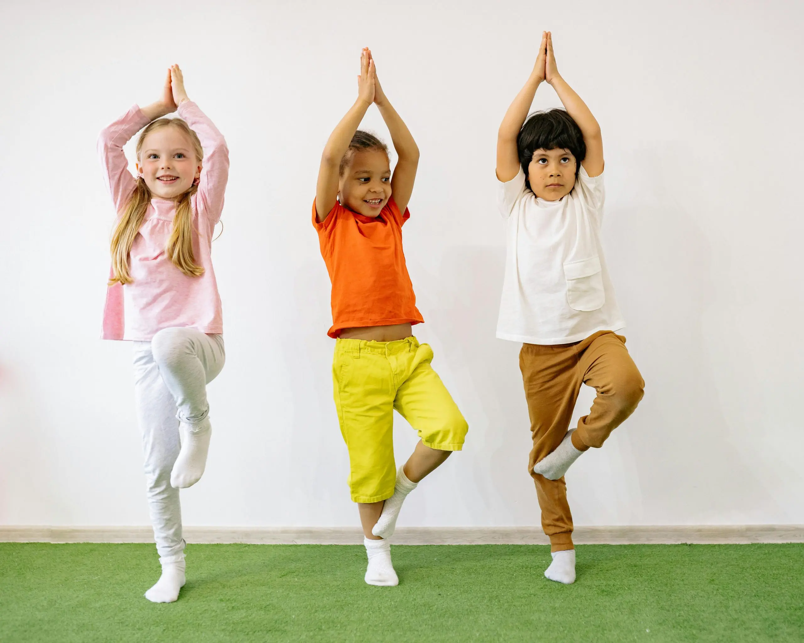 three children doing yoga
