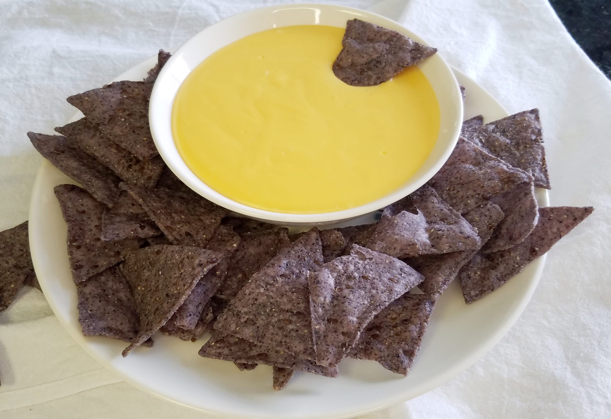 cheddar cheese dip with blue corn tortilla chips